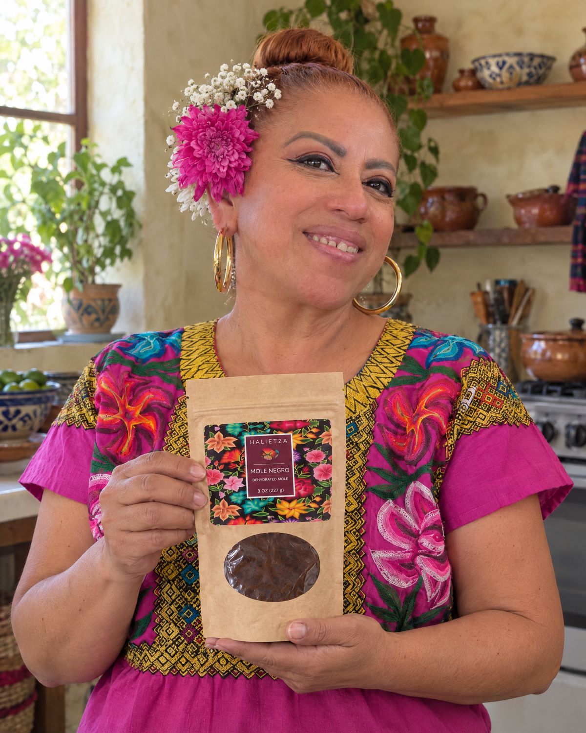 Elisa Beristain, owner of Halietza, holding a pouch of Mole Negro