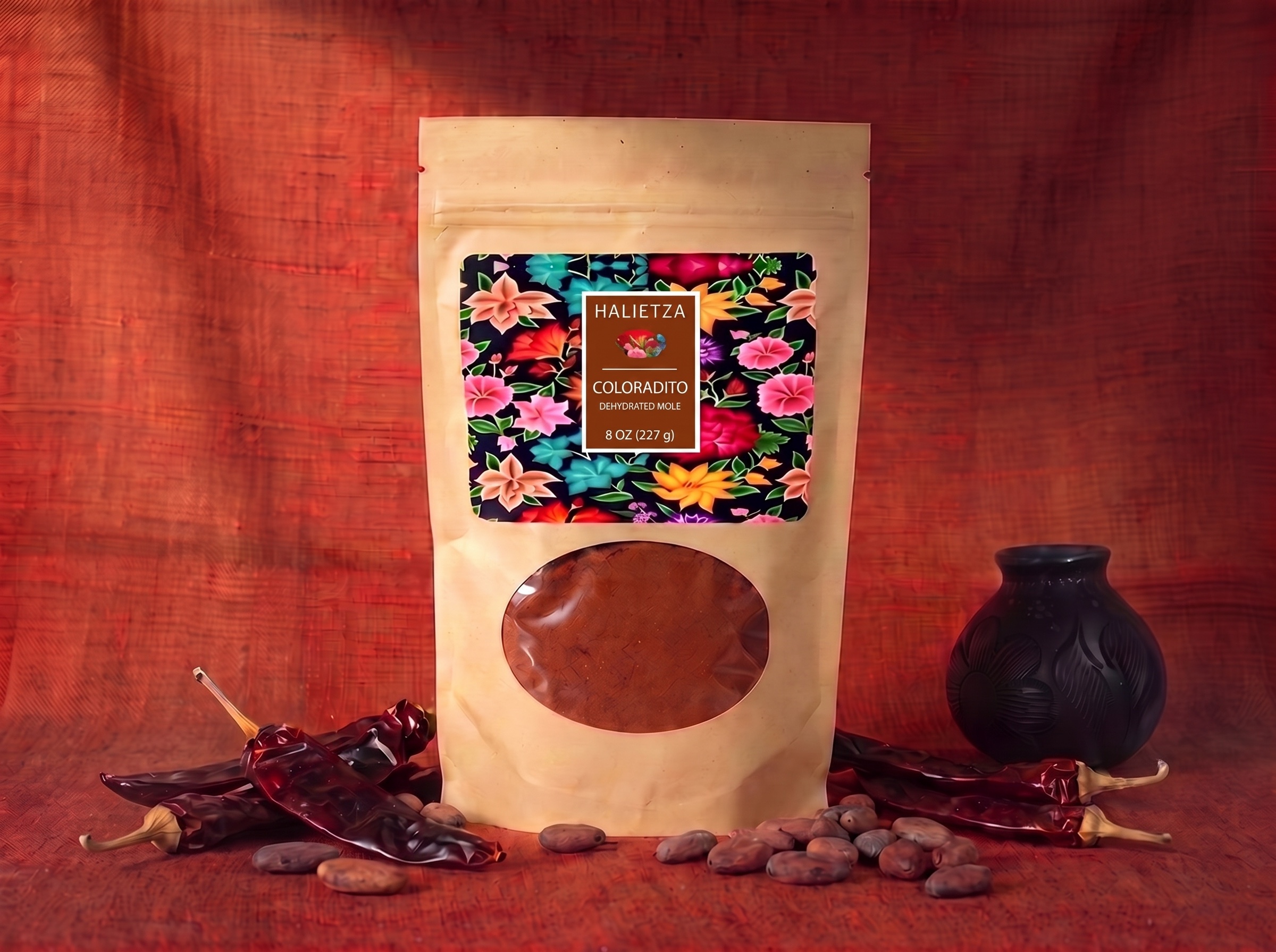 A pouch of Halietza Mole Coloradito next to a plate of brick red mole over chicken