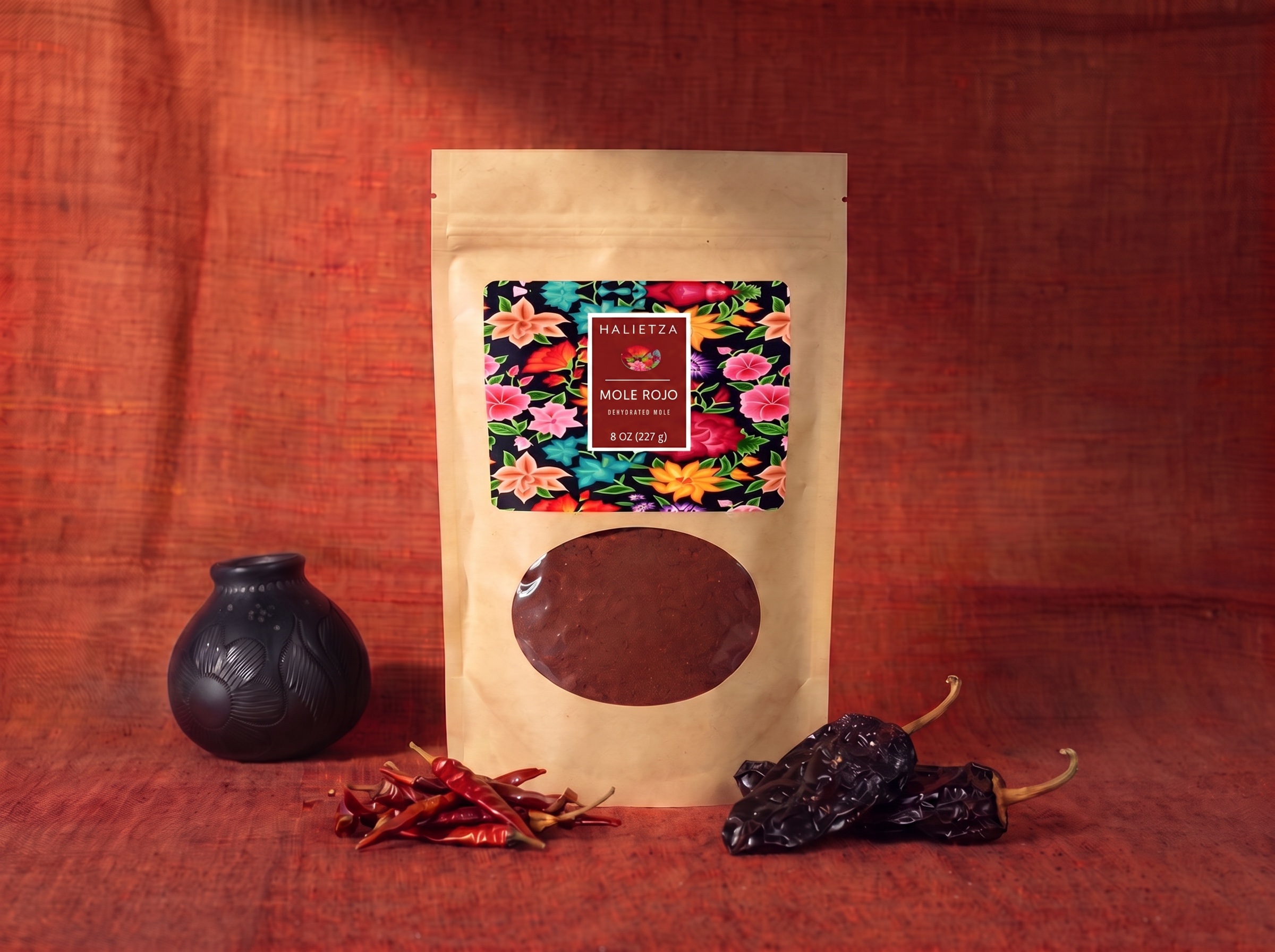 A pouch of Halietza Mole Rojo next to a bowl of finished red mole sauce