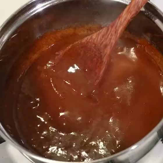 Mole stirred in the pan until it is glossy, shown with mole rojo