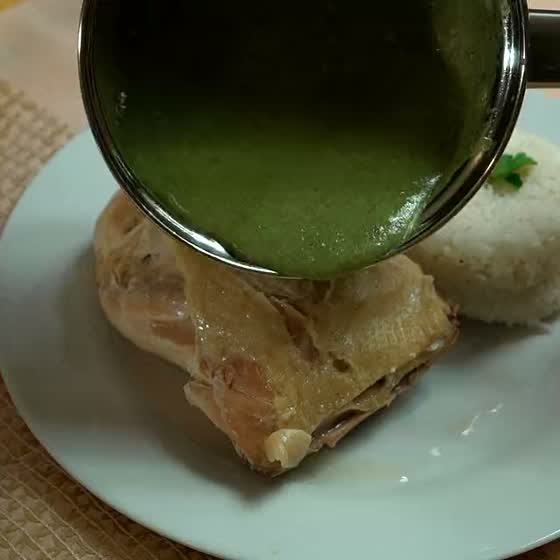 Mole verde poured over chicken with rice